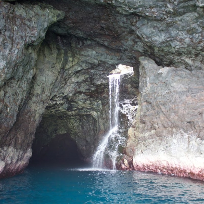 a large waterfall over some water