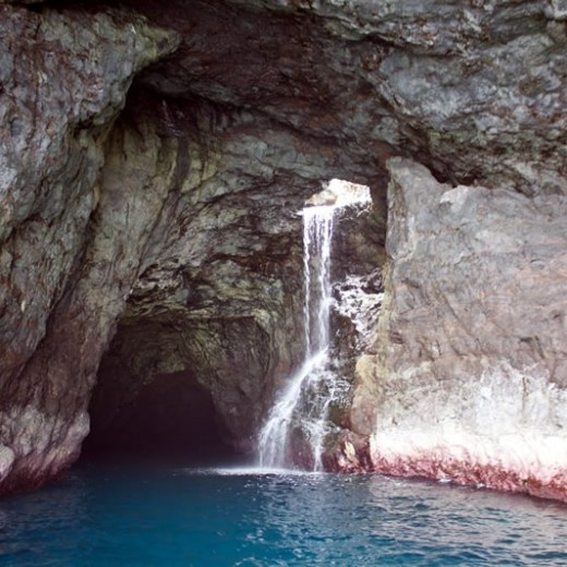 a large waterfall over some water